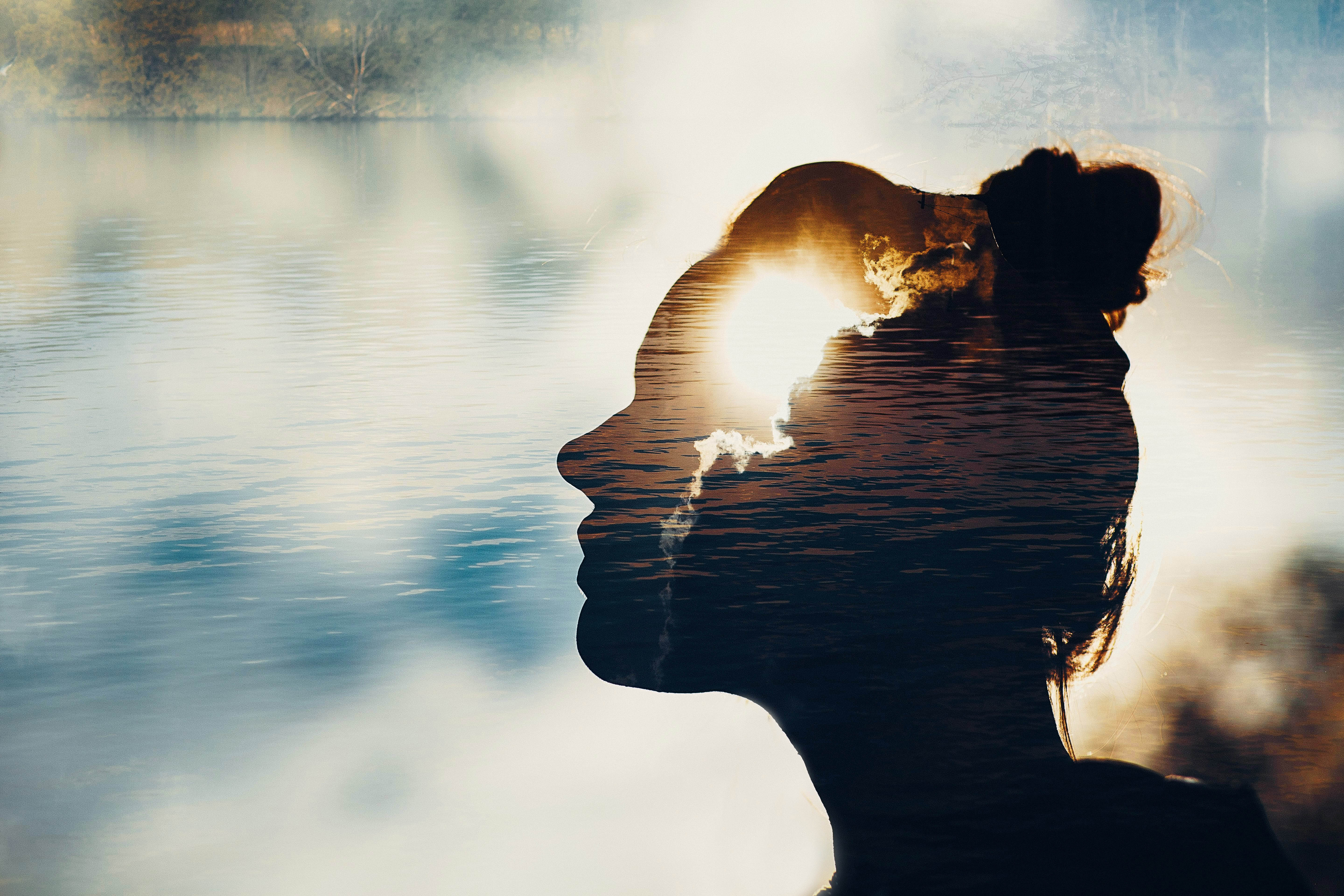 Silhouette of a woman with light focused on the forehead/brain portion of the silhouette Silhouette of a woman with light focused on the forehead/brain portion of the silhouette